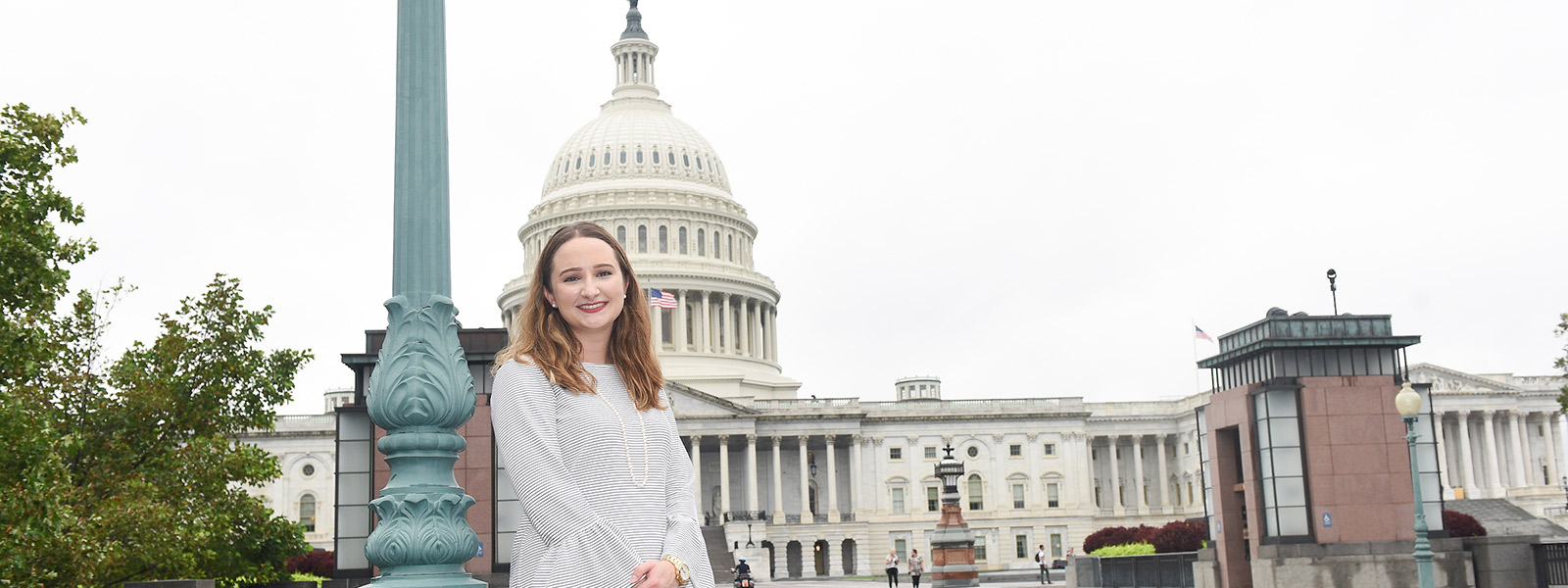 Politics student standing in front of the capitol building
