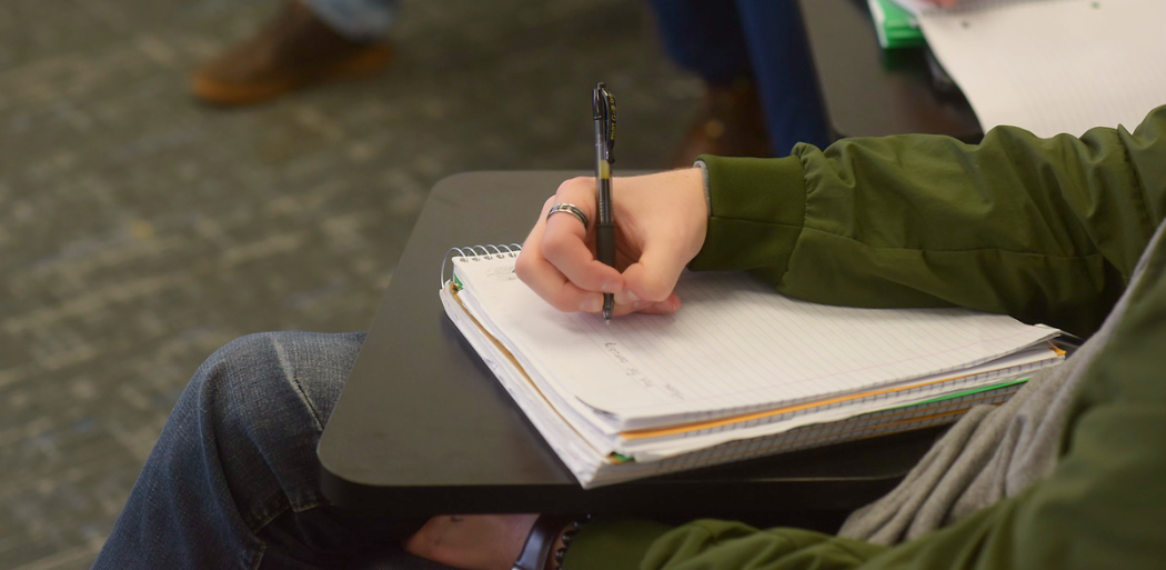 Politics students taking notes in class