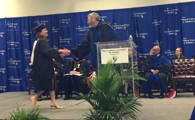 Meghan O'Brien accepts her M.A. Degree in Congressional and Presidential Studies from Dr. Dennis Coyle, Chair, Politics Department.