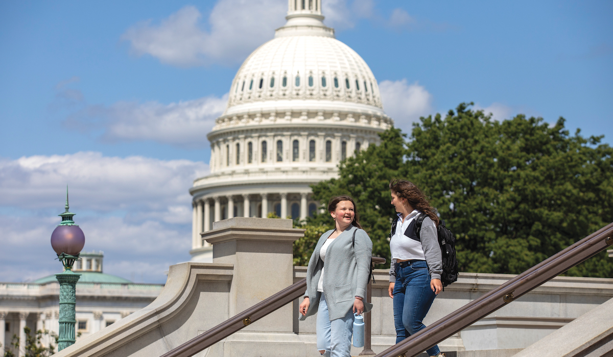 students walk in front of the Capitol building